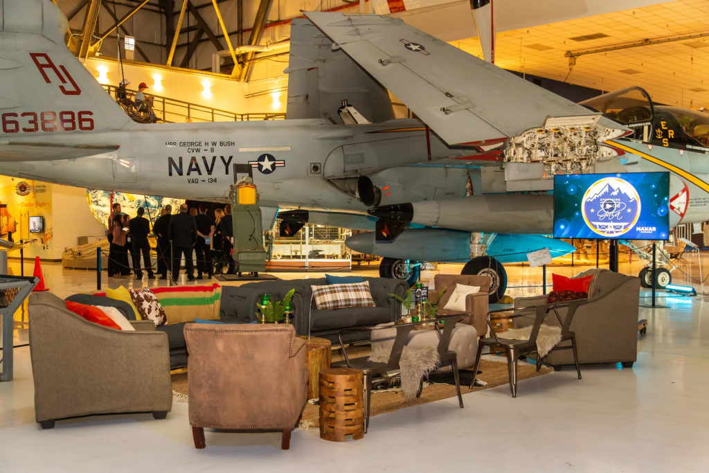 Holiday lounge furniture in front of a Navy Jet at Wings over the Rockies