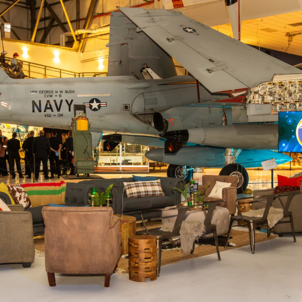 Holiday lounge furniture in front of a Navy Jet at Wings over the Rockies