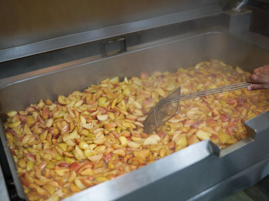 Apple chunks cooking in. large metal container