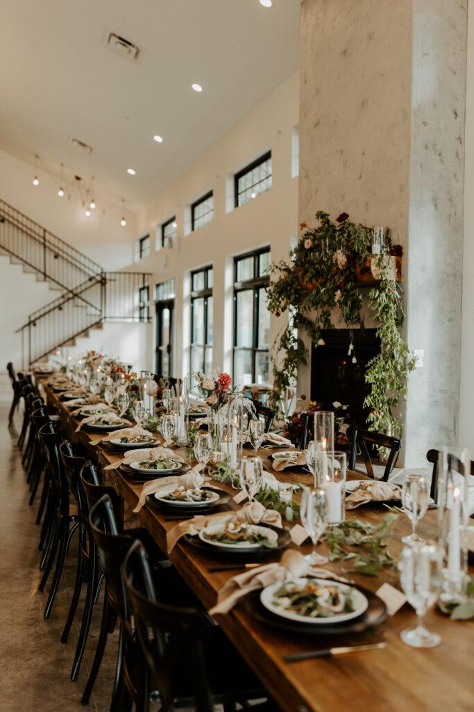 Wood tablescape with salads at each seating with black chairs